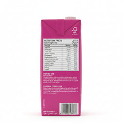 The back of a 1-liter carton in a bright magenta-pink color, displaying detailed nutrition facts, usage instructions, and a barcode in English and Arabic.