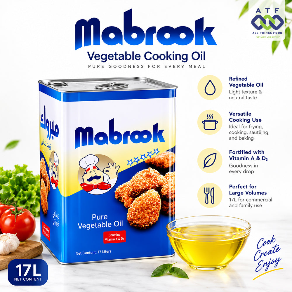 Mabrook Pure Vegetable Oil 17L metal tin packaging shown with promotional text, a glass of golden oil, and food props including tomatoes, garlic, and green leaves.