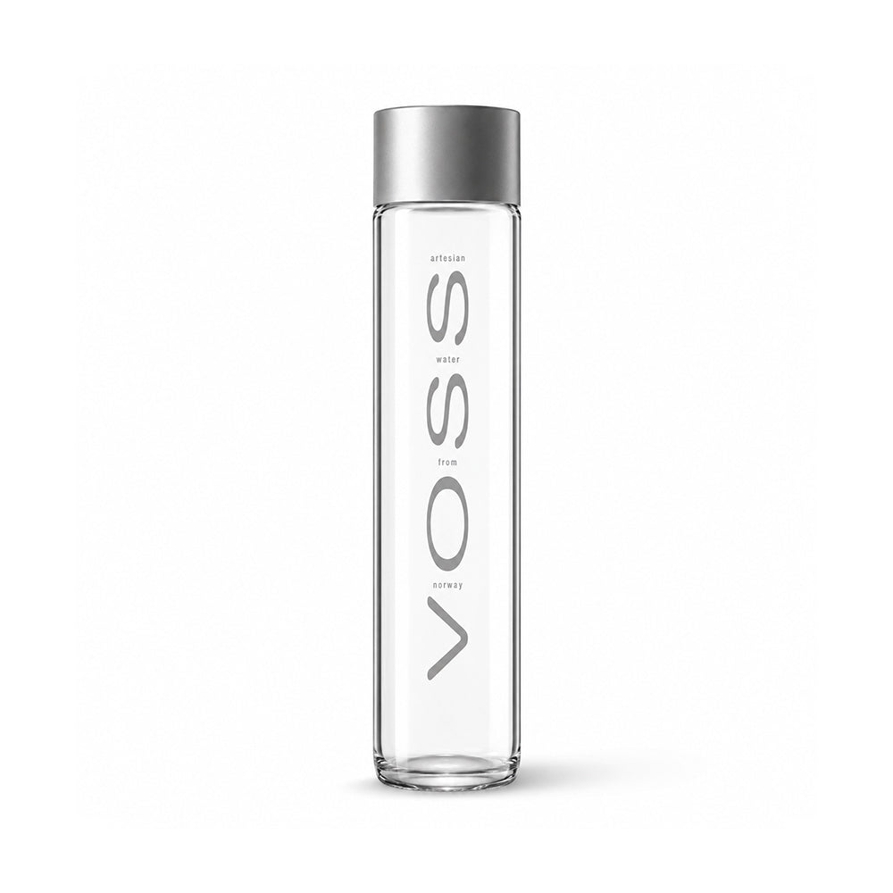A tall, slender clear glass water bottle with a metallic silver cap, featuring the brand name 'VOSS' printed vertically in gray on the front.