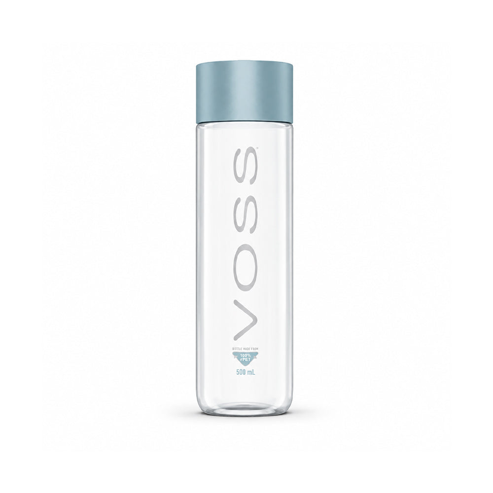 A 500 ml clear glass water bottle with a metallic light blue cap, featuring the brand name 'VOSS' printed vertically in gray on the front.