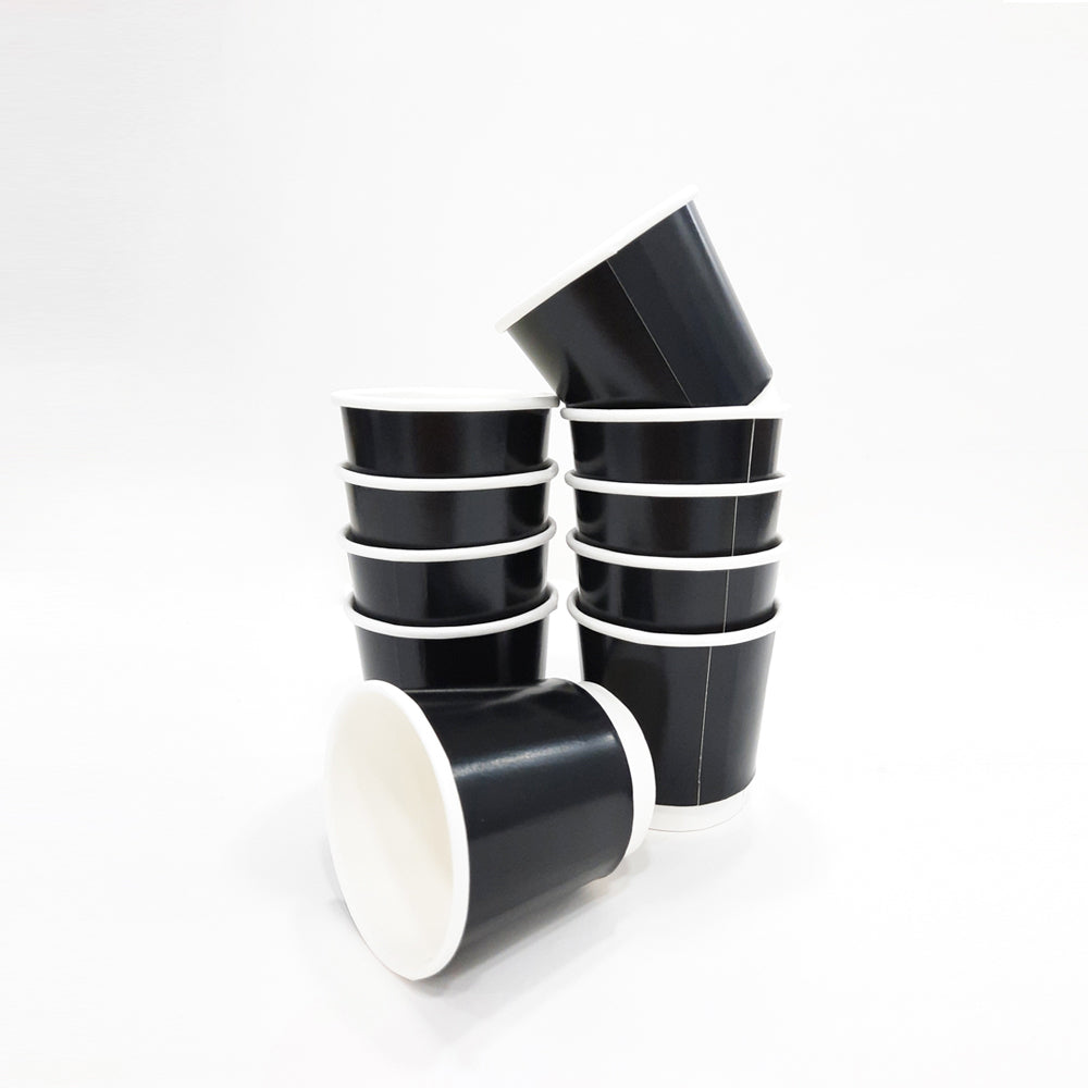 A stack of black double-walled paper coffee cups without lids.
