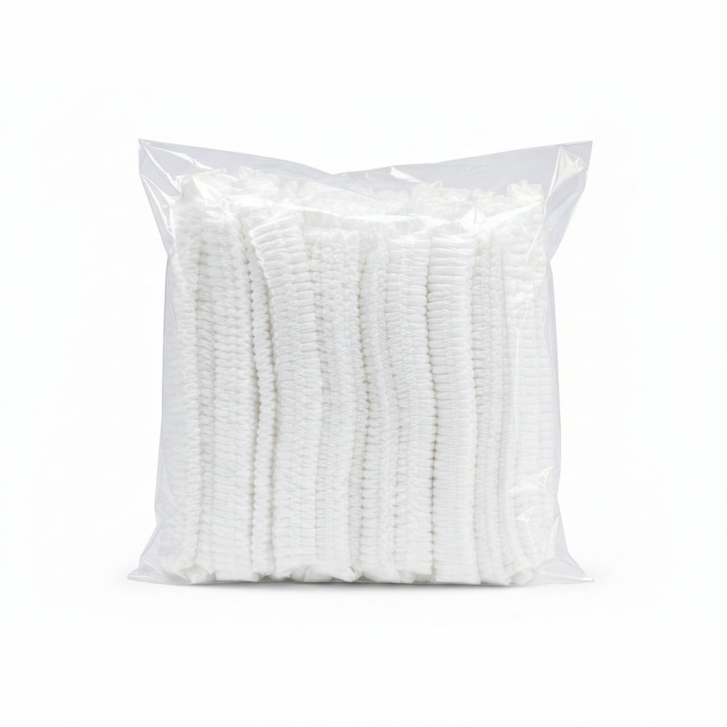 A clear plastic bag containing a stack of white textured cleaning or scrubbing pads, isolated on a white background.