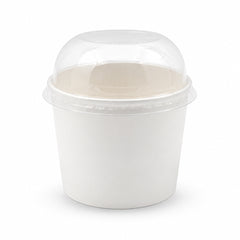 A white paper food container with a clear plastic dome lid