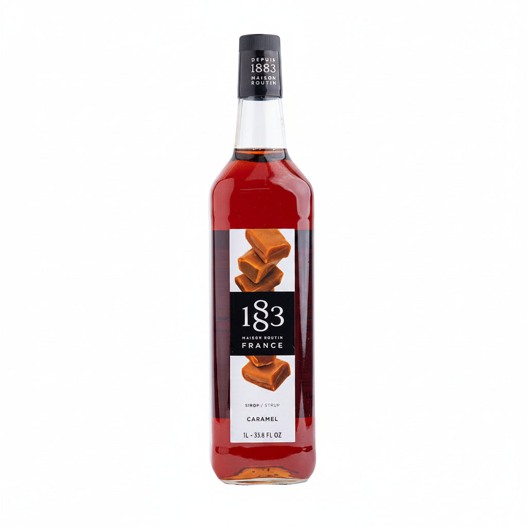 Bottle of 1883 Caramel syrup on a white background