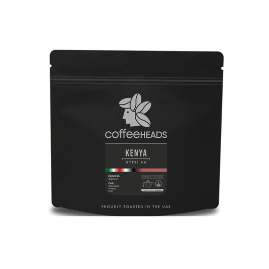 A black stand-up pouch of Coffeeheads Kenya Nyeri AA whole bean coffee, shown with a soft shadow.