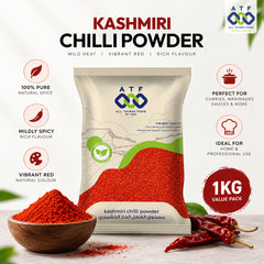 A 1kg package of ATF All Time Food By SF Kashmiri Chilli Powder, displayed with a wooden bowl of red powder, whole red chilies, and descriptive text highlighting its vibrant red color, mild heat, and rich flavor.