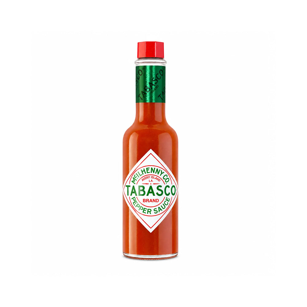 A bottle of Tabasco Pepper Sauce. The bottle is filled with red-orange sauce, featuring the classic white diamond-shaped Tabasco label with green text, a green neck band, and a red cap.