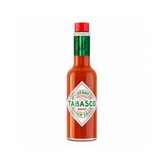 A bottle of Tabasco Pepper Sauce. The bottle is filled with red-orange sauce, featuring the classic white diamond-shaped Tabasco label with green text, a green neck band, and a red cap.
