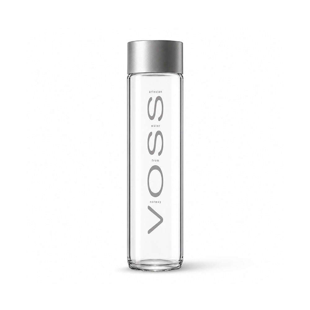 A tall, clear glass water bottle with a metallic silver cap, featuring the brand name 'VOSS' printed vertically in gray on the front.