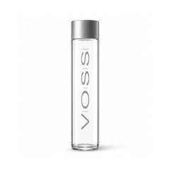 A tall, slender clear glass water bottle with a metallic silver cap, featuring the brand name 'VOSS' printed vertically in gray on the front.