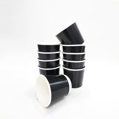 A stack of black double-walled paper coffee cups without lids.