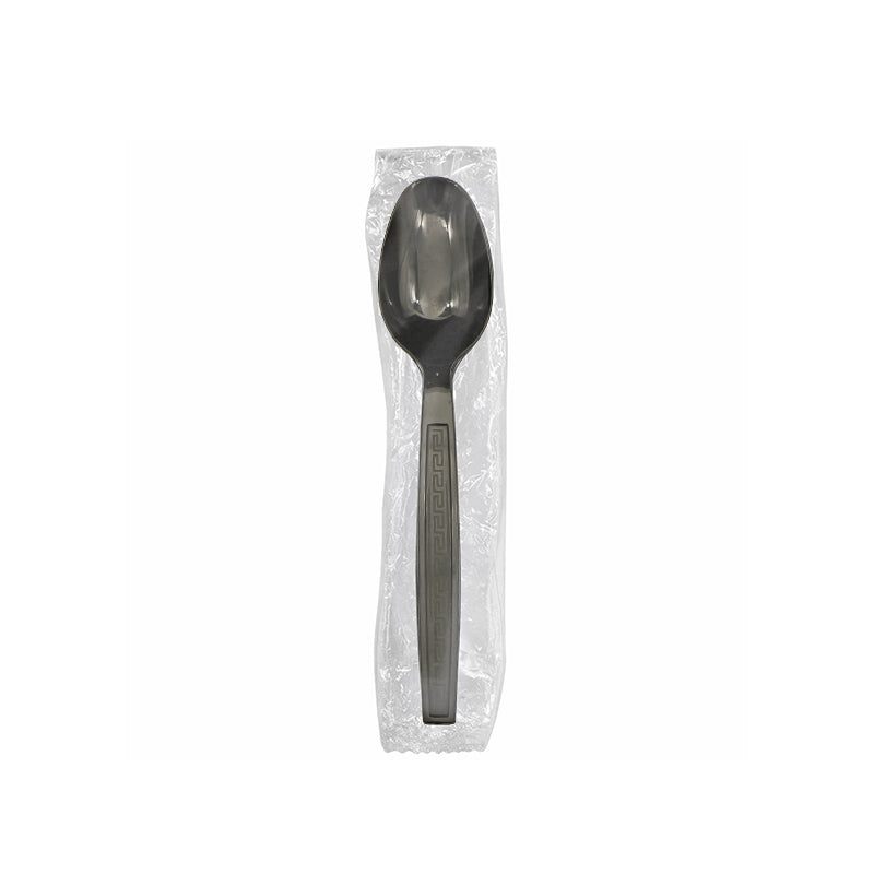 Black spoon in a clear plastic package on a white background