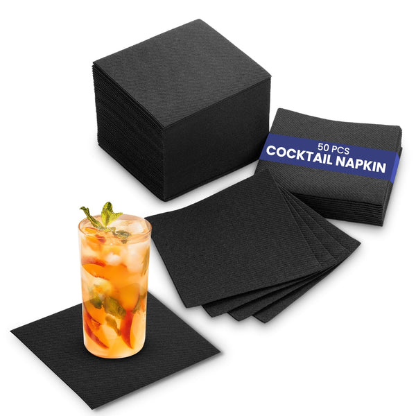 A pack of 50 black cocktail paper napkins displayed with a glass of a cocktail garnished with a slice of orange, indicating the product's use.