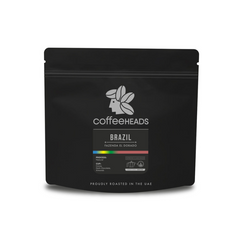 Black coffee packaging with 'Coffeeheads' branding on a white background