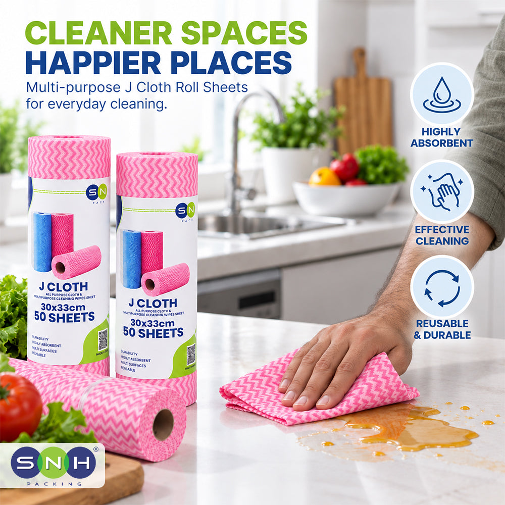 Pink and blue chevron-patterned J Cloth roll sheets shown in a kitchen setting, with a hand wiping a spill on a countertop. The image includes marketing text and icons highlighting absorbency, cleaning effectiveness, and durability.