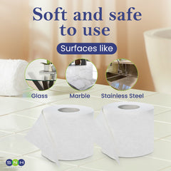 Two rolls of toilet paper on a tiled floor with text indicating safety on glass, marble, and stainless steel surfaces.