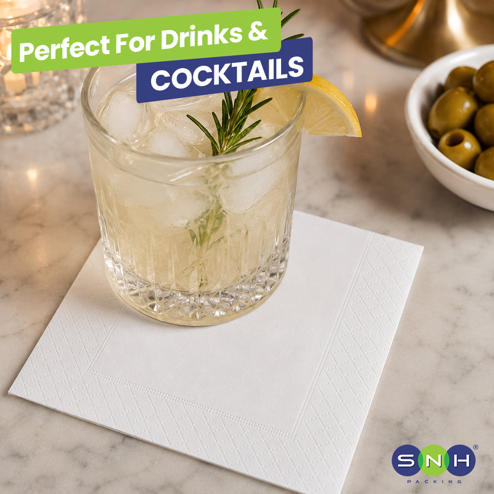 Cocktail glass with lemon and rosemary garnish on a marble surface, with 'SNH' branding.